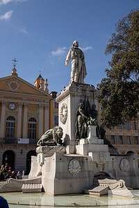 Large marble monument in Place Garibaldi, featuring a statue of Giuseppe Garibaldi and intricate sculptures at its base, surrounded by classic buildings and a public square in Nice, France. This peaceful and flat plaza is a senior-friendly place to visit in Nice, offering historical charm and easy access.