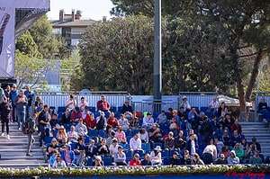 Spectators, many of them older adults, seated in shaded bleachers during a daytime match at the Barcelona Open tennis tournament. The relaxed atmosphere and accessible seating highlight a senior-friendly experience in the heart of the city.