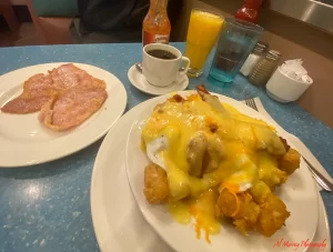Frans Restaurant breakfast of Tater Tots Benedict and pea meal bacon on the side