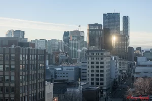 Early morning view of downtown Montreal with a mix of modern high-rises and older buildings under soft sunlight, showcasing the urban landscape where many downtown hotels are located. The image visually supports content focused on choosing a hotel in downtown Montreal.