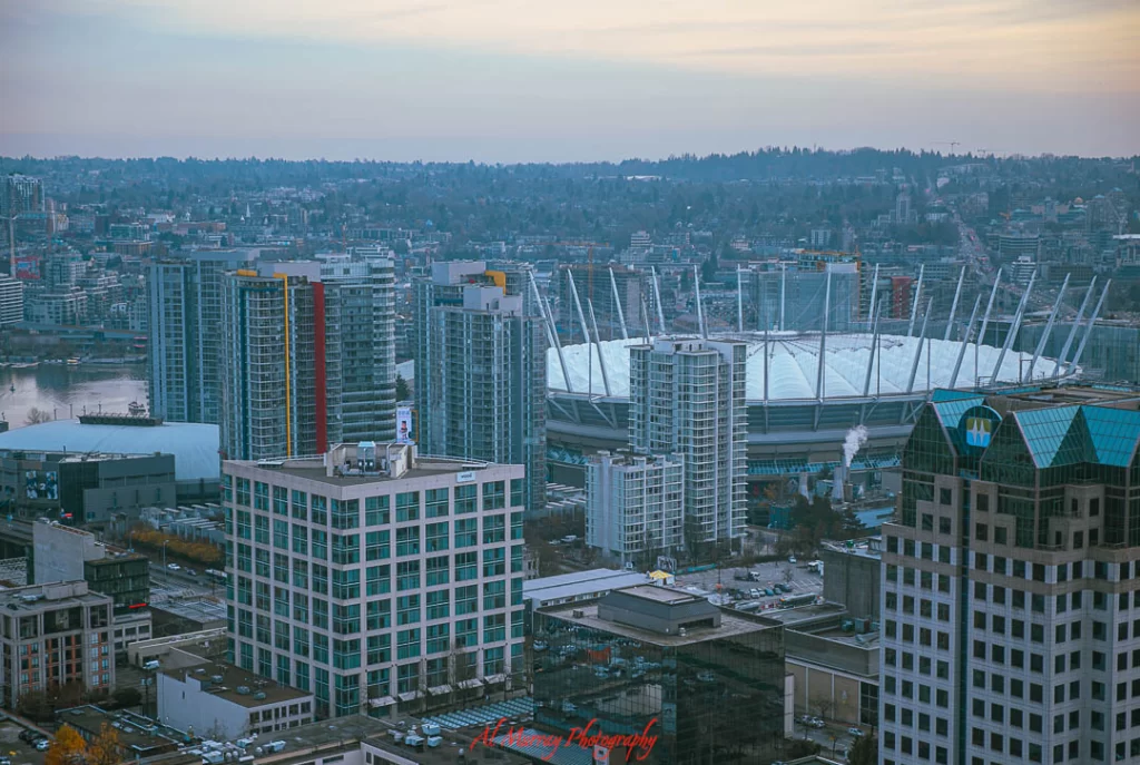 Vancouver budget stays suburbs Aerial view of downtown Vancouver with BC Place Stadium prominently featured, surrounded by high-rise buildings and city streets. This image offers a helpful perspective for visitors wondering how to get to BC Place in the heart of the city.