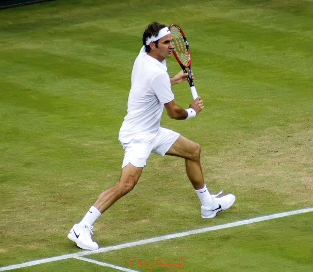 Male tennis player in motion preparing a backhand shot on the grass surface of Centre Court Wimbledon. The crisp white attire and focused stance highlight the prestige and intensity of this iconic tennis venue.