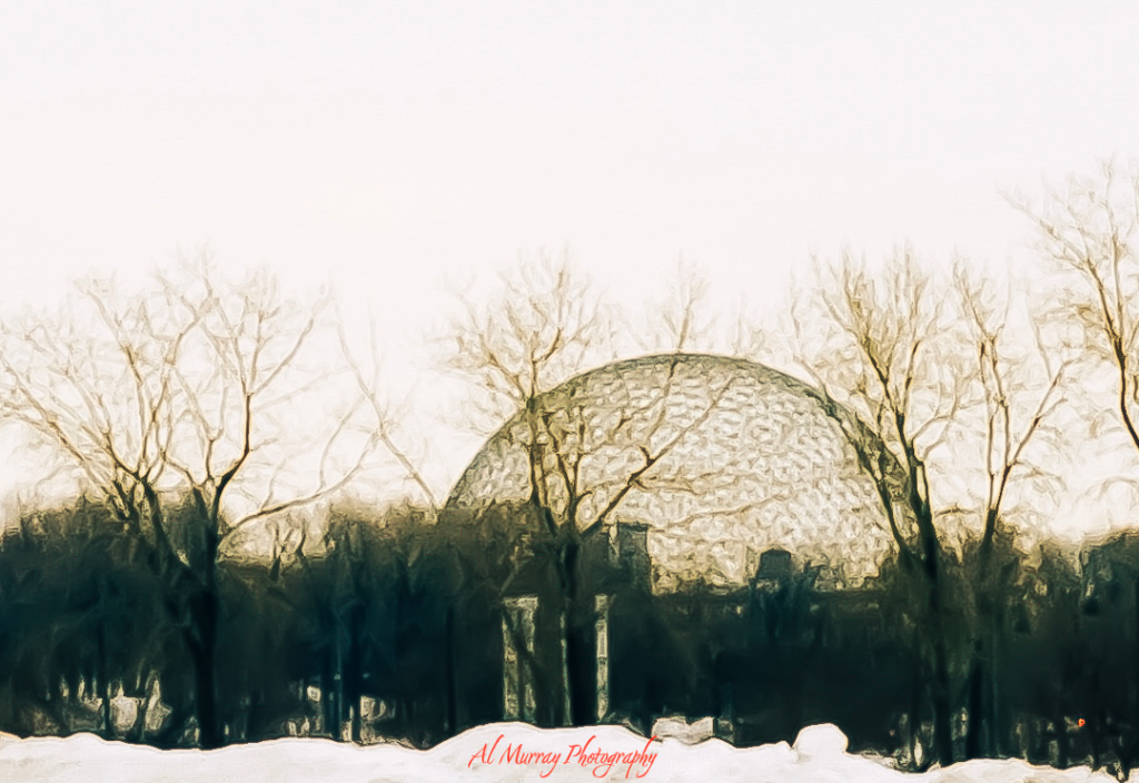 The Montreal Biosphère peeks through bare winter trees, its geodesic dome softened by snow and muted light. This quiet, atmospheric view captures one of the hidden romantic places in Montreal during winter, ideal for a peaceful stroll with a loved one.
