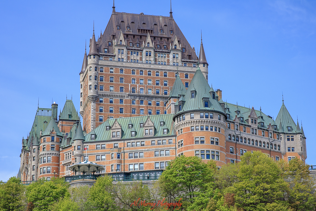 The iconic Château Frontenac towers above lush greenery under a bright blue sky, its castle-like architecture evoking old-world romance. A must-see landmark for any Quebec City Valentine’s Day itinerary for 3 days, offering both luxury and history in the heart of Old Quebec.
