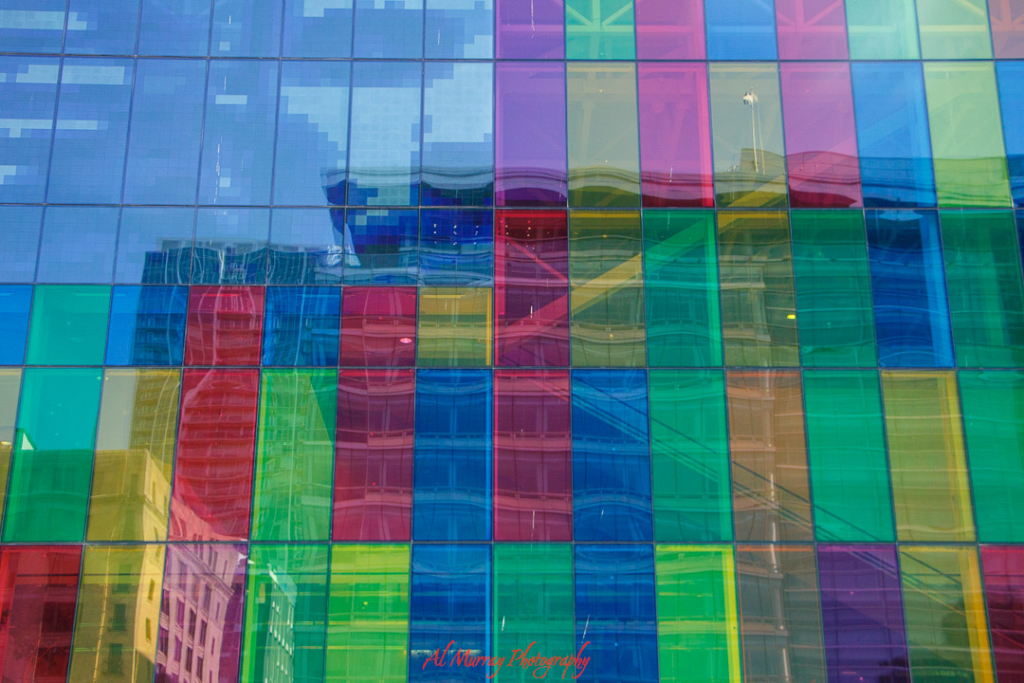 Colorful glass panels of Montreal’s Palais des congrès reflect surrounding city buildings in a vibrant mosaic of reds, greens, blues, and yellows. Visiting this architectural landmark is a senior-friendly activity offering visual interest, easy access, and proximity to museums, cafés, and cultural spaces.
