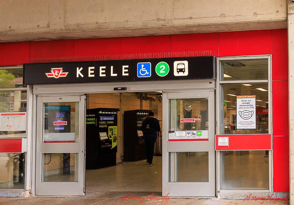 Entrance to Keele subway station in Toronto with signage showing "KEELE", accessibility symbol, Line 2, and bus connection, highlighting transit access in walkable neighbourhoods toronto for tourists.
