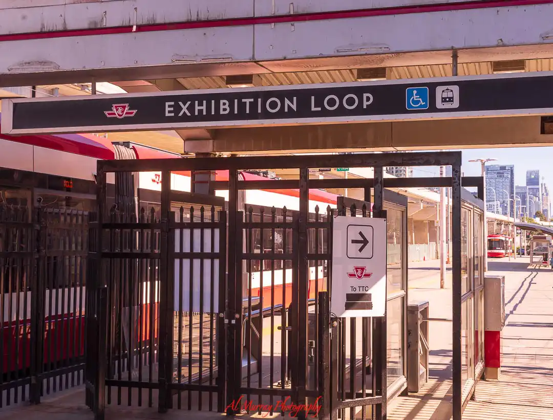 Entrance to Exhibition Loop transit stop in Toronto with signage reading "EXHIBITION LOOP" and icons for accessibility and streetcar, showing convenient public transit access in areas where to stay in Toronto without a car is easy