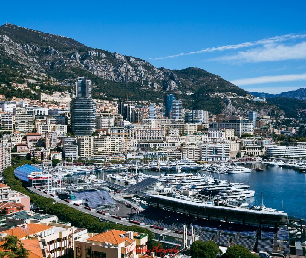 Scenic harbor filled with yachts and waterfront buildings set against steep green mountains and a bright blue sky. A destination like this helps explain why cruises are good for seniors with mobility issues, offering access to beautiful ports and memorable views with less walking and fewer travel logistics to manage independently.