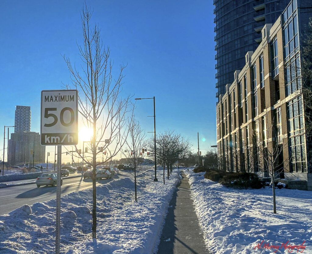 things to do in Toronto indoors Snow covered Toronto sidewalk beside a busy road and tall buildings on a bright winter day. The wintry street scene helps set the context for planning things to do in Toronto in bad weather